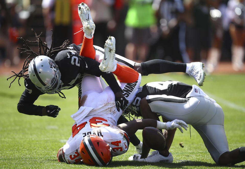 <p>Cleveland Browns running back Carlos Hyde (34) fumbles under Oakland Raiders defensive back Reggie Nelson (27) and defensive back Dominique Rodgers-Cromartie (45) during the first half of an NFL football game in Oakland, Calif., Sunday, Sept. 30, 2018. Hyde recovered the fumble. (AP Photo/Ben Margot) </p>