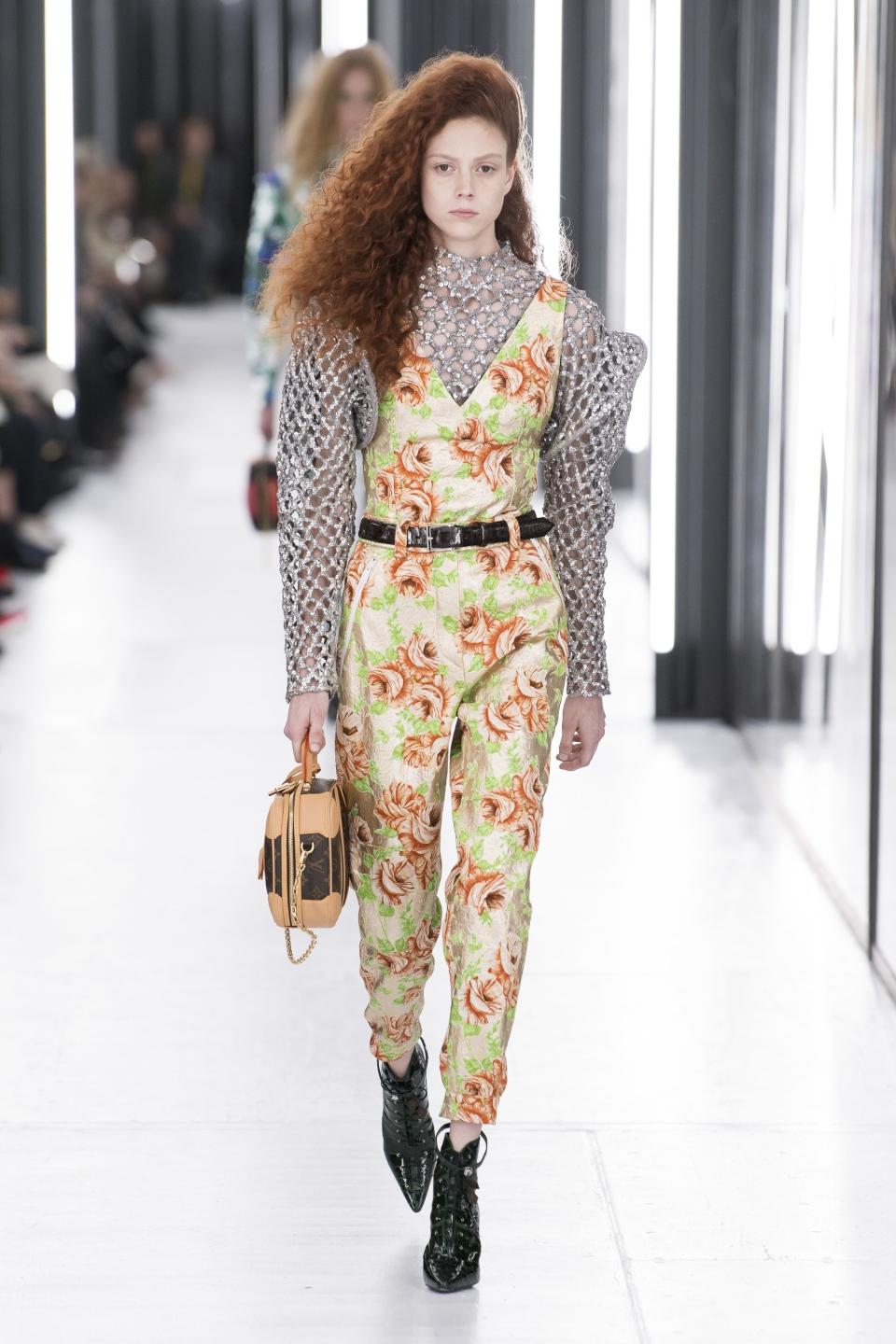 Louis Vuitton’s Spring 2019 look elevates the jumpsuit with floral printing and a chain mail top.
