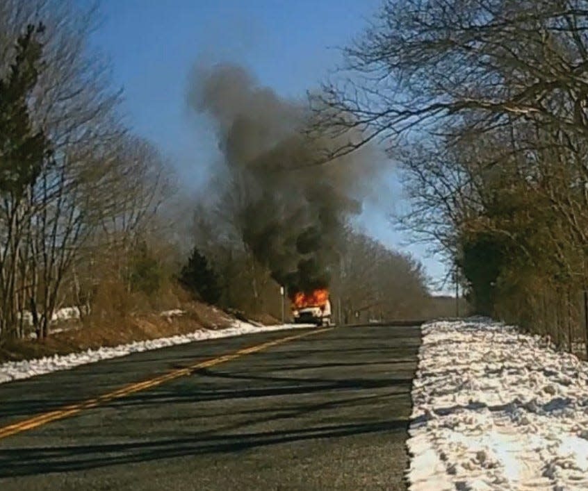 An image taken from Swansea Police dashcam footage shows a U-Haul van engulfed in flames on Reed Street on Feb. 19, 2024. Prosecutors say the van was used in the robbery of a courier taking cash from cannabis companies to a bank. The image was released in a criminal complaint in U.S. District Court.
