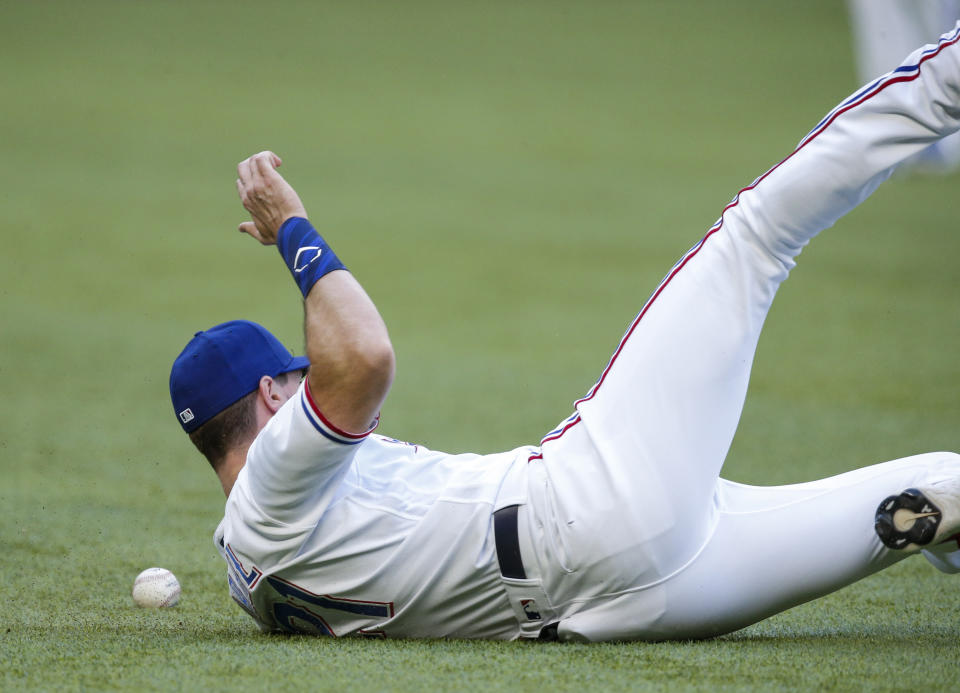 Texas Rangers left fielder David Dahl is unable to catch a hit by San Diego Padres' Jurickson Profar during the first inning of a baseball game, Saturday, April 10, 2021, in Arlington, Texas. (AP Photo/Brandon Wade)