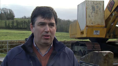 Beef farmer Dessie McManus is interviewed by Reuters in front of the 'border buster' JCB digger on the border near Kinawley in Northern Ireland and Swanlinbar in Ireland, in this still image taken from video on February 6, 2019. REUTERS/Reuters TV