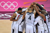 The United States players join hands as they celebrate winning the Men's Basketball gold medal game between the United States and Spain. (Getty Images)