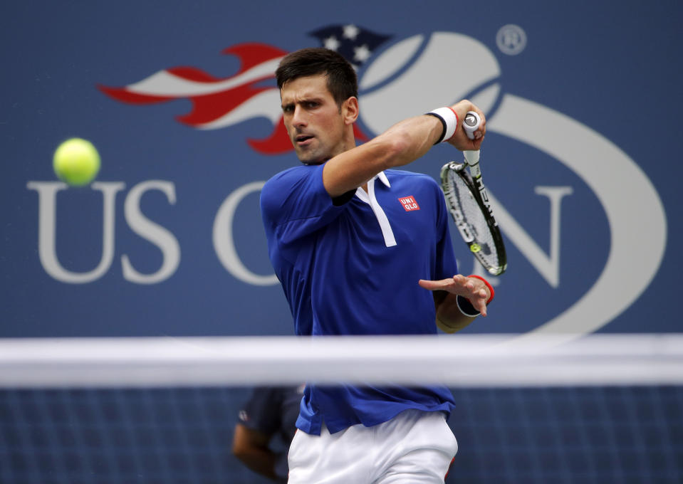FILE - Novak Djokovic, of Serbia, returns a shot to Andreas Seppi, of Italy, during the third round of the U.S. Open tennis tournament, Friday, Sept. 4, 2015, in New York. The 2023 U.S. Open begins Aug. 28. (AP Photo/Matt Rourke, File)