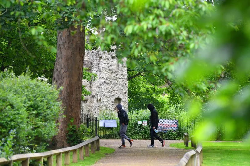 Two people walking in Reigate Castle Grounds