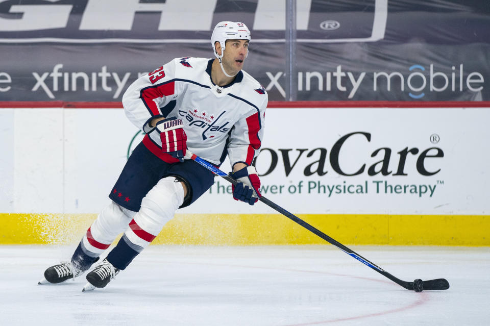 FILE- In this April 17, 2021, file photo, Washington Capitals' Zdeno Chara controls the puck during the first period of an NHL hockey game against the Philadelphia Flyers, Saturday, in Philadelphia. Chara is returning to the team he started his career with after agreeing to terms on a one-year deal with the New York Islanders. It will be the 44-year-old 24th NHL season. (AP Photo/Chris Szagola, File)