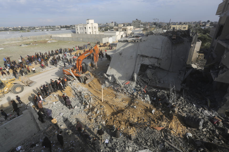 Palestinians look at the destruction after an Israeli strike on a residential building in Rafah, Gaza Strip, Friday, Feb. 16, 2024. (AP Photo/Hatem Ali)