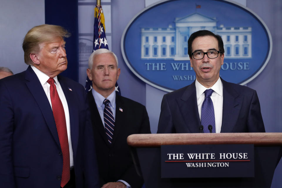 Treasury Secretary Steven Mnuchin speaks as President Donald Trump and Vice President Mike Pence listen during a briefing about the coronavirus in the James Brady Briefing Room, Wednesday, March 25, 2020, in Washington. (AP Photo/Alex Brandon)