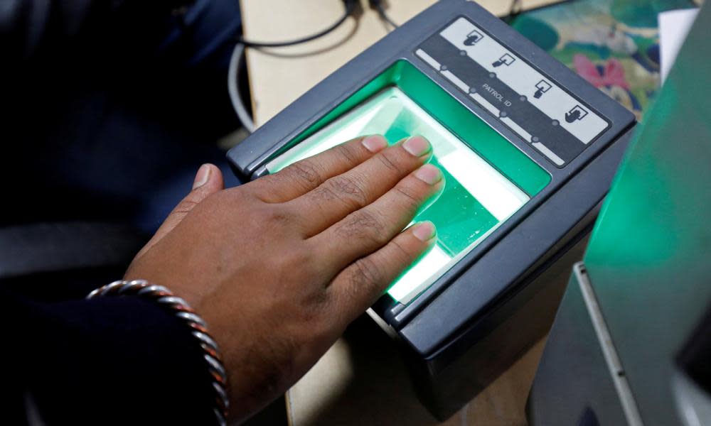 A woman goes through the process of finger scanning for the Aadhaar database system in New Delhi