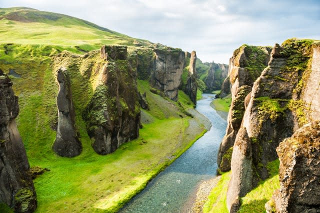 Fjadrargljufur canyon with river and big rocks.