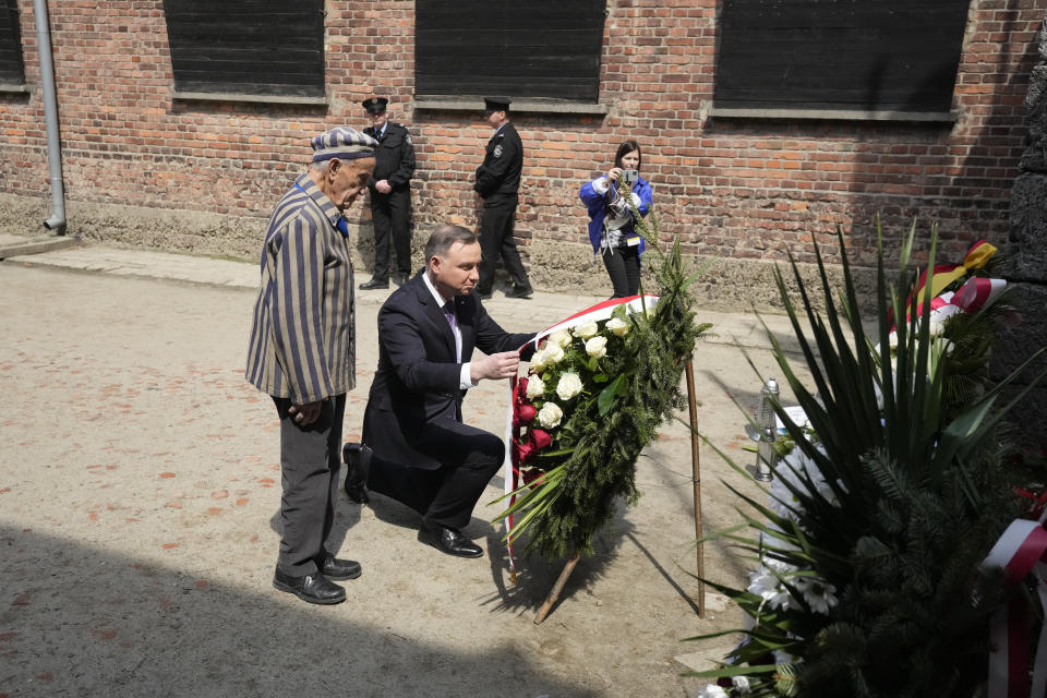 CAPTION CORRECTS THE NAME - Poland's President Andrzej Duda, centre, and Auschwitz Survivor from U.S. Edward Mosberg, attend the March of the Living annual observance that was not held for two years due to the global COVID-19 pandemic, in Oswiecim, Poland, Thursday, April 28, 2022. Only eight survivors and some 2,500 young Jews and non-Jews are taking part in the annual march that is scaled down this year because of the war in neighboring Ukraine that is fighting Russia's invasion. (AP Photo/Czarek Sokolowski)