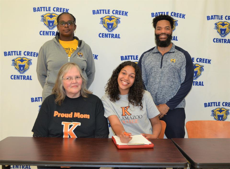 Battle Creek Central's Shayla Ardis committed to play basketball at Kalamazoo College during a signing ceremony, along with her coaches and family, at BCC High School on Tuesday.