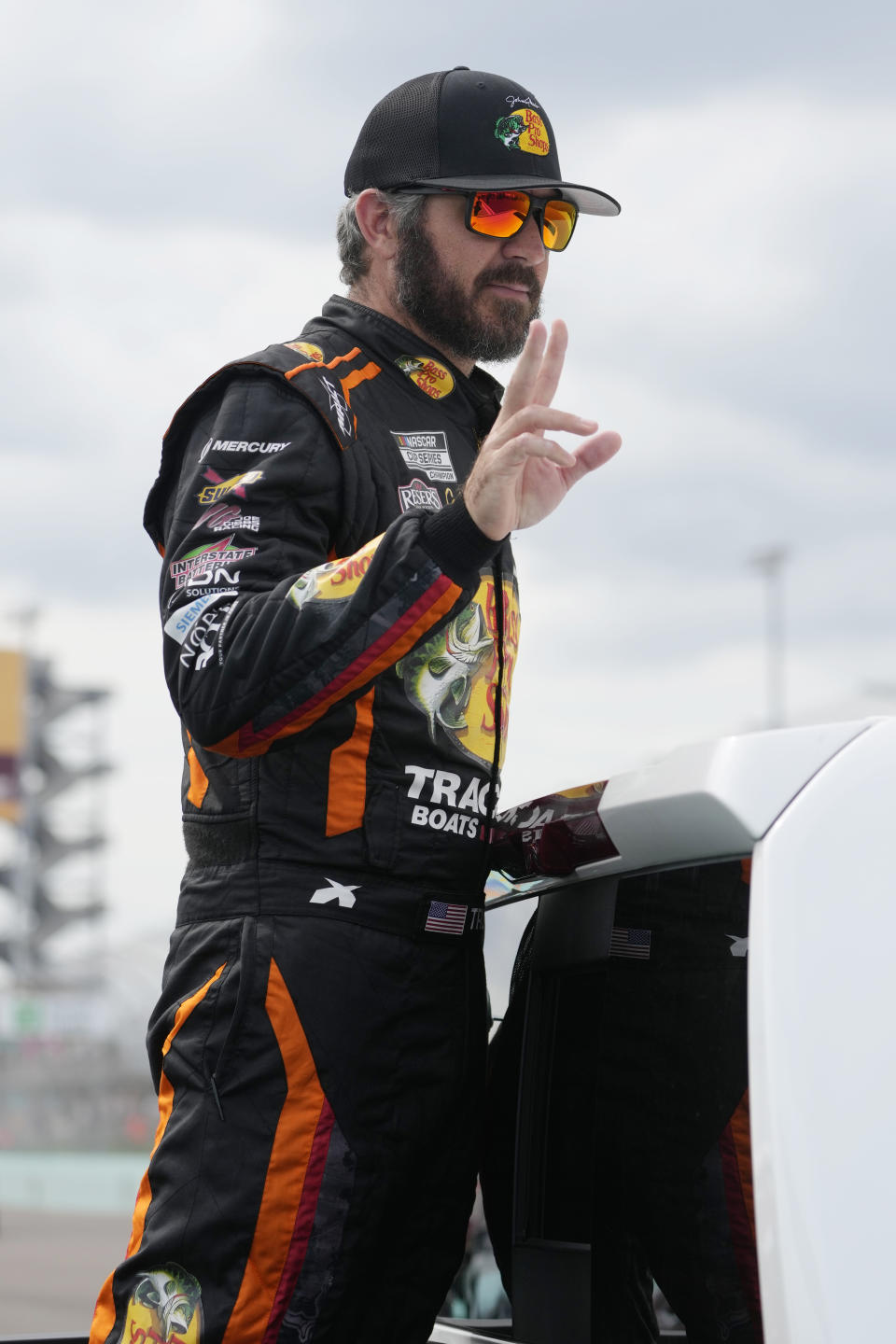 Driver Martin Truex Jr. gestures before the start of the NASCAR Cup Series auto race at Homestead-Miami Speedway, Sunday, Oct. 22, 2023 in Homestead, Fla. (AP Photo/Marta Lavandier).