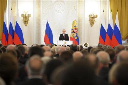 Russian President Vladimir Putin (back) addresses the Federal Assembly, including State Duma deputies, members of the Federation Council, regional governors and civil society representatives, at the Kremlin in Moscow March 18, 2014. REUTERS/Alexei Druzhinin/RIA Novosti/Kremlin