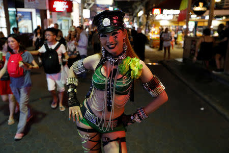 A woman promotes a go-go dance bar in Pattaya, Thailand March 25, 2017. REUTERS/Jorge Silva