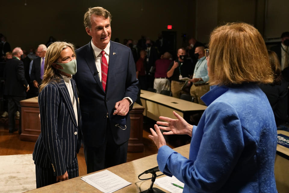 Republican gubernatorial candidate Glenn Youngkin, center, and his wife, Suzanne, left, greet debate moderator Susan Page, right after a debate with Democrat Terry McAuliffe at the Appalachian School of Law in Grundy, Va., Thursday, Sept. 16, 2021. (AP Photo/Steve Helber)