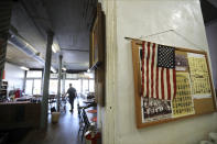 A solitary customer pulls up a chair in the dining room at Hildebrant's Deli, which opened in 1879, in Augusta, Ga., Monday, April 6, 2020. A restaurant or bar can take a huge step toward profitability off the business it generates during Masters week. (Curtis Compton/Atlanta Journal-Constitution via AP)