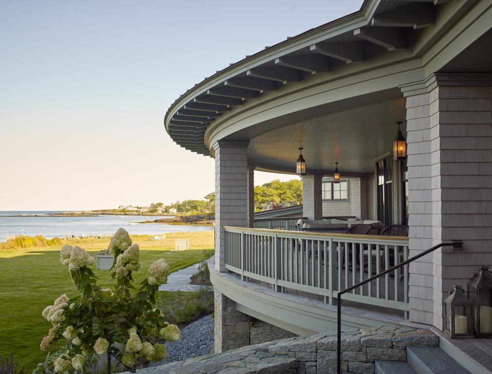 Knickerbocker Group took the house’s original porch, at the back of the house and no wider than eight feet, and transformed it into this luxurious veranda with views of Casco Bay. Among the additions: a new copper roof, pendant lighting by Hinkley Lighting, and a mahogany railing. The rafter tails and railing trim are done in Pigeon by Farrow & Ball. The shingles are H2BO by Maibec.