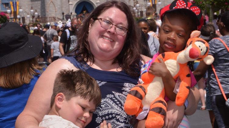 Alicia Erchul pictured at Walt Disney World holding Morgan Price in her arms as her son Aidan cuddles up to her. (Photo: Courtesy of Alicia Erchul)