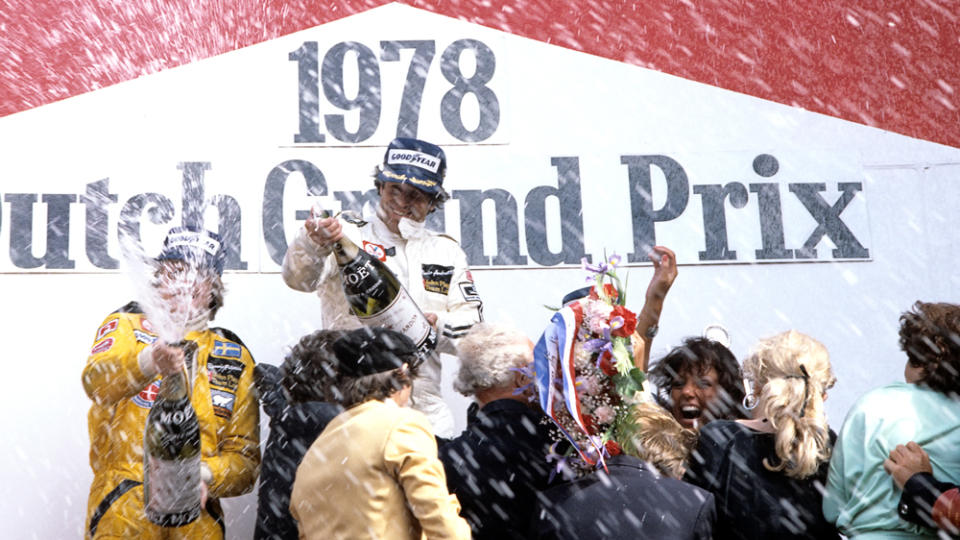 Teammates Mario Andretti and Ronnie Peterson (left) celebrate finishing first and second, respectively, at the 1978 Dutch Grand Prix.