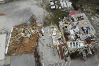 A damaged business is seen in the aftermath of Hurricane Sally, Thursday, Sept. 17, 2020, in Perdido Key, Fla. Rivers swollen by Hurricane Sally's rains threatened more misery for parts of the Florida Panhandle and south Alabama on Thursday, as the storm's remnants continued to dump heavy rains inland that spread the threat of flooding to Georgia and the Carolinas. (AP Photo/Angie Wang)