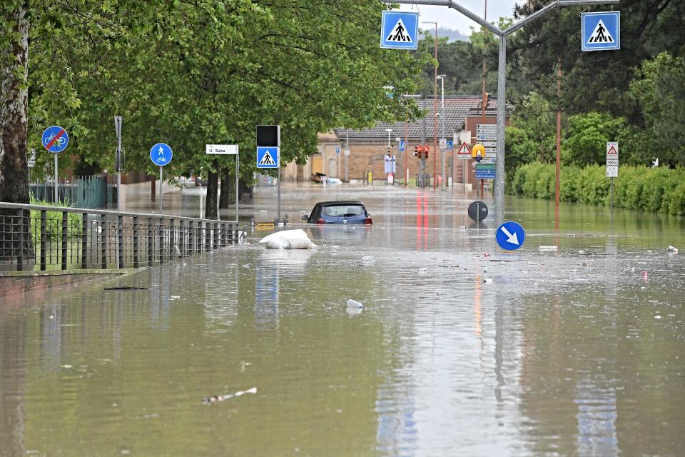 A picture taken in Cesena on May 17, 2023 shows a flooded street after heavy rains have caused major flooding in central Italy, where trains were stopped and schools were closed in many towns while people were asked to leave the ground floors of their homes and to avoid going out.