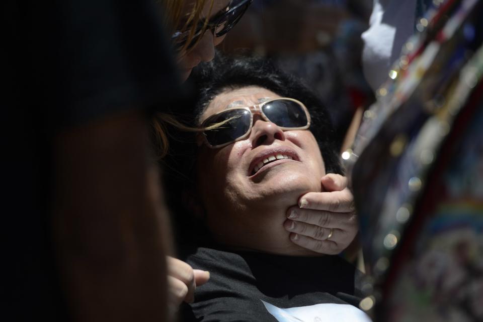 <p>Lucyvette Padro grieves during the burial of her son Angel Candelario Padro, a 28-year-old nurse and National Guard member, as he is laid to rest at the Guanica municipal cemetery in Puerto Rico, June 18, 2016. (AP Photo/Carlos Giusti) </p>