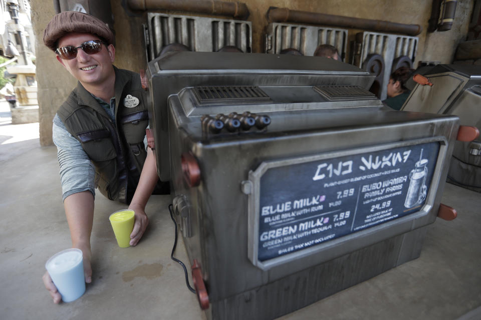 Blue Milk and Green Milk are among the refreshments for sale to guests during a preview of the Star Wars themed land, Galaxy's Edge in Hollywood Studios at Disney World, Tuesday, Aug. 27, 2019, in Lake Buena Vista, Fla. The attraction will open Thursday to park guests. (AP Photo/John Raoux)