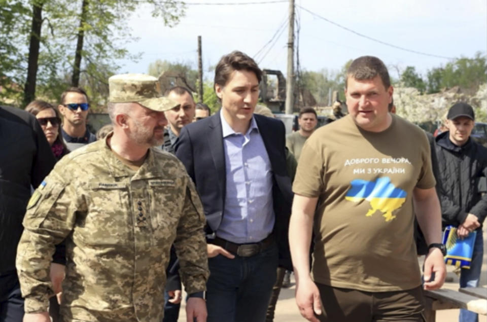 This image provided by the Irpin Mayor's Office shows Canadian Prime Minister Justin Trudeau walking with mayor Oleksandr Markushyn, right, in Irpin, Ukraine, Sunday, May 8, 2022. Trudeau made a surprise visit to Irpin on Sunday. The city was severely damaged during Russia’s attempt to take Kyiv at the start of the war. (Irpin Mayor's Office via AP)