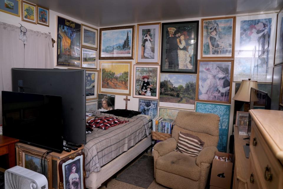 Art posters cover the walls in one resident's room at 233 High St. in Woonsocket, one of the last remaining rooming houses in Rhode Island.