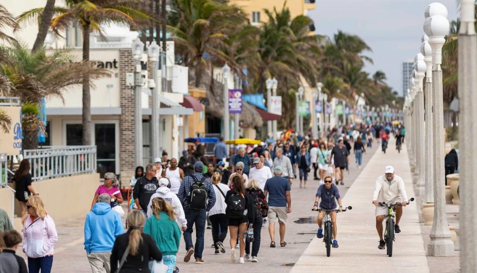 People make their way down the Hollywood Beach Broadwalk on Monday, Feb. 19, 2024.