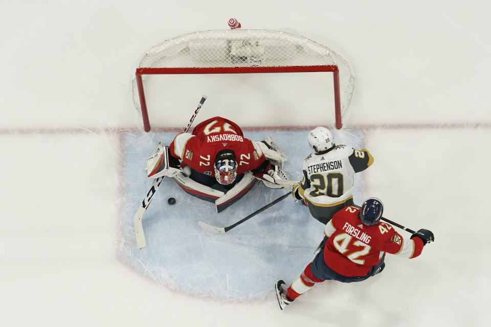 Florida Panthers goaltender Sergei Bobrovsky (72) stops a shot on goal by Vegas Golden Knights center Chandler Stephenson (20) during the second period of Game 3 of the NHL hockey Stanley Cup Finals, Thursday, June 8, 2023, in Sunrise, Fla. (AP Photo/Marta Lavandier)