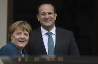 Irish Prime Minister Leo Varadkar and German Chancellor Angela Merkel smile at the waiting media outside Farmleigh House in Dublin, Ireland, Thursday, April 4, 2019. (AP Photo/Peter Morrison)