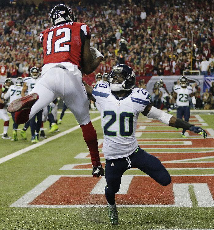 Atlanta Falcons wide receiver Mohamed Sanu (12) makes a touchdown catch against Seattle Seahawks cornerback Jeremy Lane (20) during the second half of an NFL football divisional football game, Saturday, Jan. 14, 2017, in Atlanta. (AP Photo/John Bazemore)