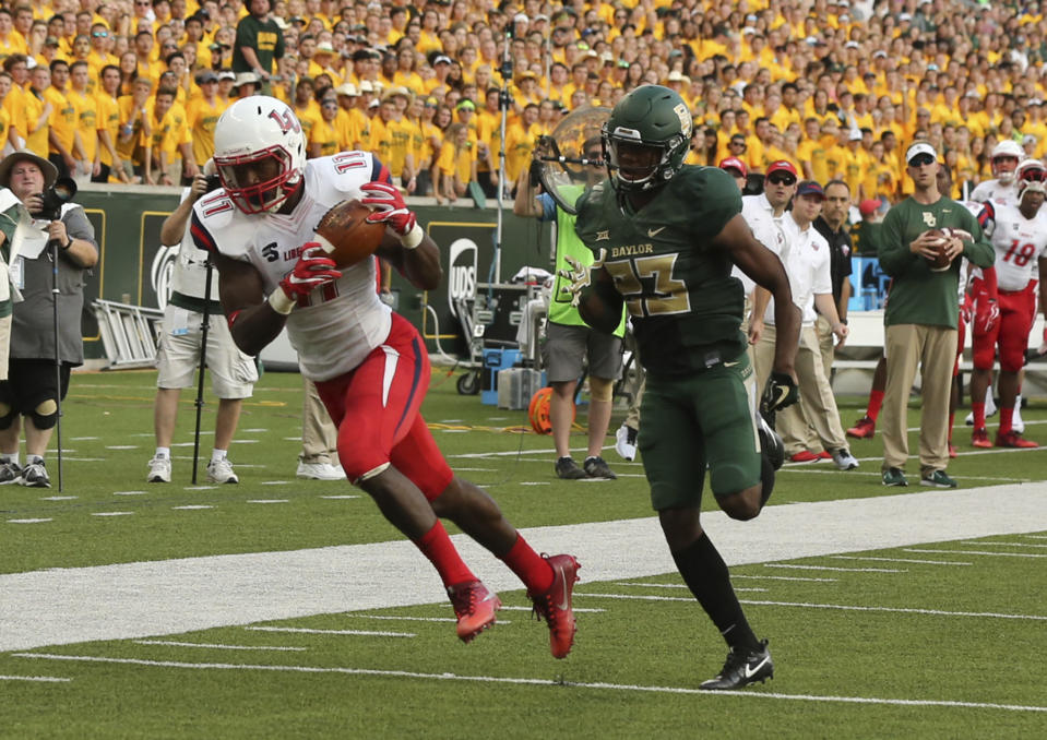 Liberty wide receiver Antonio Gandy-Golden, left, scores past Baylor safety Jourdan Blake, right, in the first half of an NCAA college football game, Saturday, Sept. 2, 2017, in Waco, Texas. (Rod Aydelotte/Waco Tribune Herald, via AP)