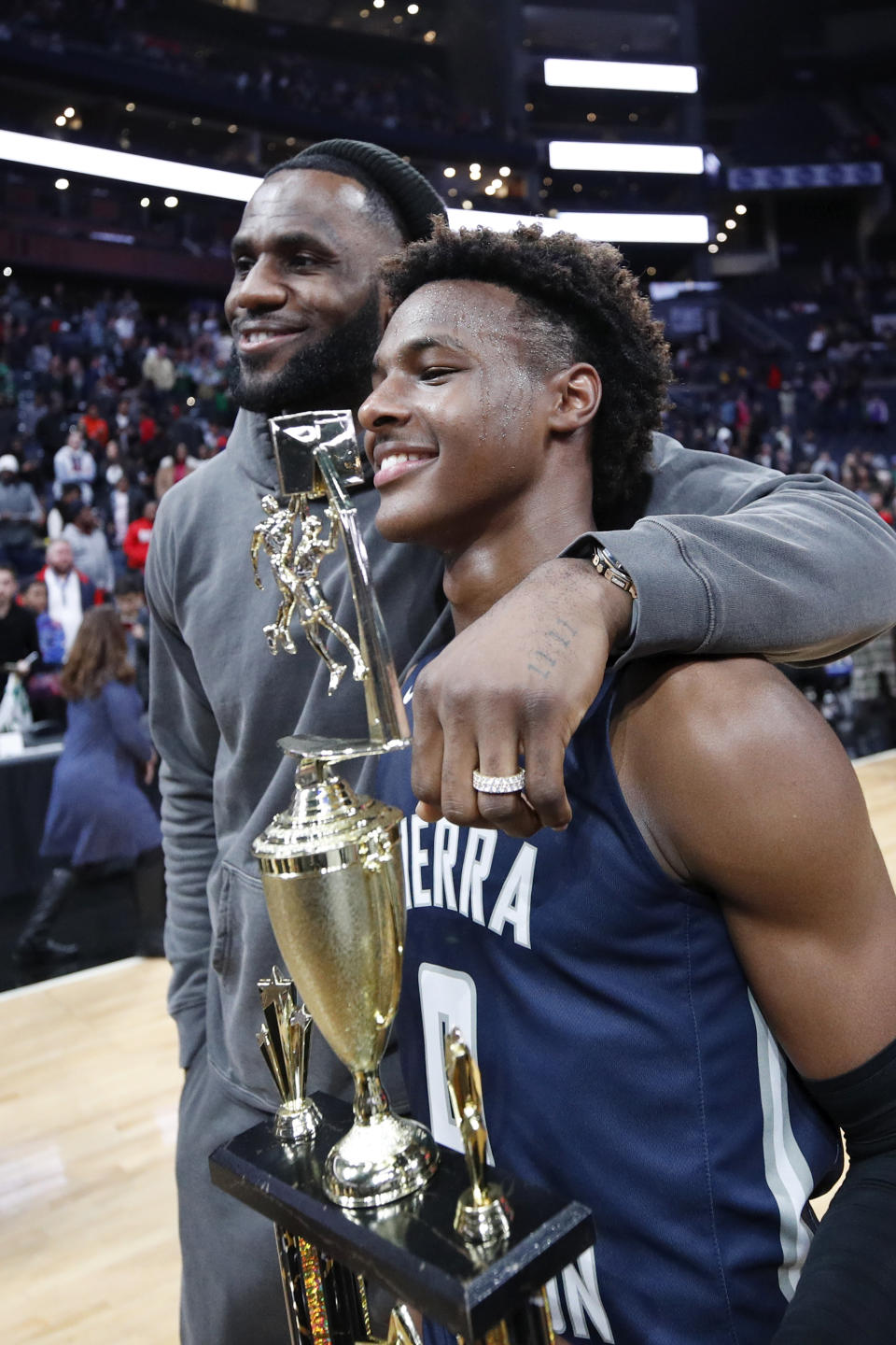 LeBron ‘Bronny’ James Jr. #0 of Sierra Canyon High School with his father <span class="caas-xray-inline-tooltip"><span class="caas-xray-inline caas-xray-entity caas-xray-pill rapid-nonanchor-lt" data-entity-id="LeBron_James" data-ylk="cid:LeBron_James;pos:2;elmt:wiki;sec:pill-inline-entity;elm:pill-inline-text;itc:1;cat:Athlete;" tabindex="0" aria-haspopup="dialog"><a href="https://search.yahoo.com/search?p=LeBron%20James" data-i13n="cid:LeBron_James;pos:2;elmt:wiki;sec:pill-inline-entity;elm:pill-inline-text;itc:1;cat:Athlete;" tabindex="-1" data-ylk="slk:LeBron James;cid:LeBron_James;pos:2;elmt:wiki;sec:pill-inline-entity;elm:pill-inline-text;itc:1;cat:Athlete;" class="link ">LeBron James</a></span></span> of the Los Angeles Lakers following the Ohio Scholastic Play-By-Play Classic against St. Vincent-St. Mary High School at Nationwide Arena on December 14, 2019 in Columbus, Ohio.