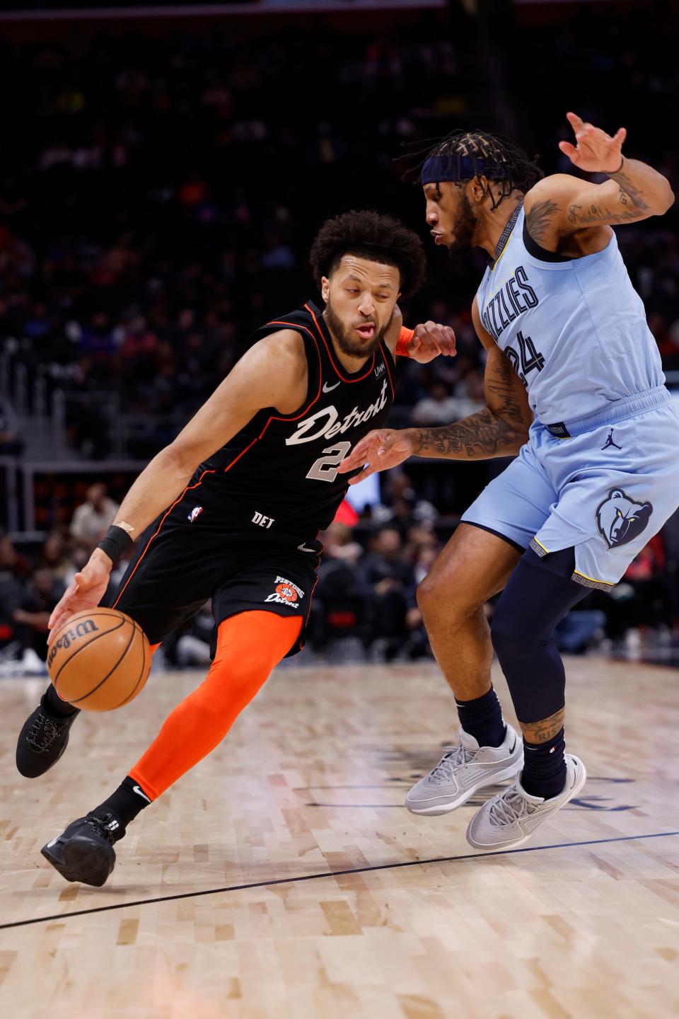 Pistons guard Cade Cunningham dribbles defended by Grizzlies forward Lamar Stevens in the first half on Monday, April 1, 2024, at Little Caesars Arena.