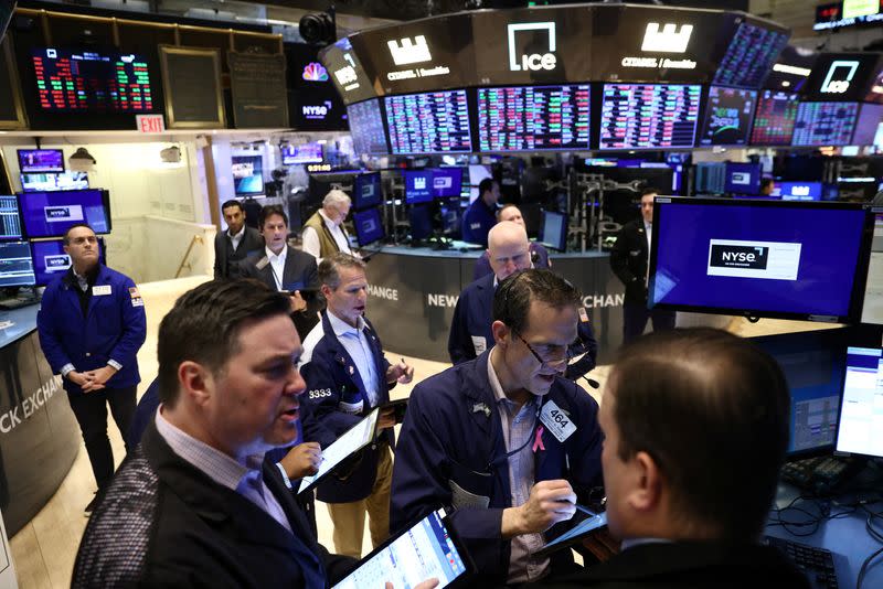 Traders work on the trading floor at the New York Stock Exchange (NYSE) in New York City