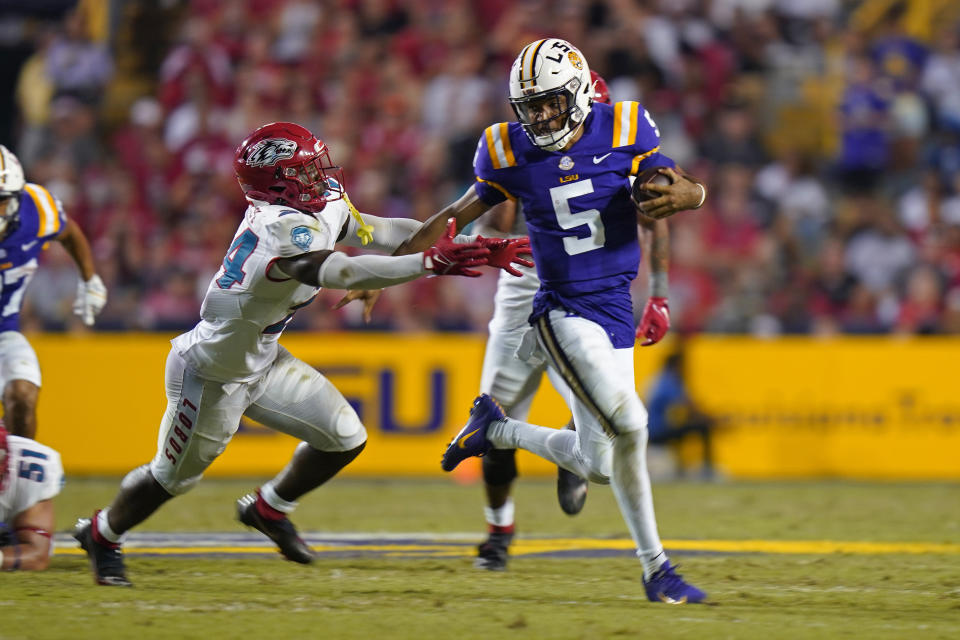 LSU quarterback Jayden Daniels (5) carries against New Mexico safety AJ Haulcy (24) in the second half of an NCAA college football game in Baton Rouge, La., Saturday, Sept. 24, 2022. LSU won 38-0. (AP Photo/Gerald Herbert)