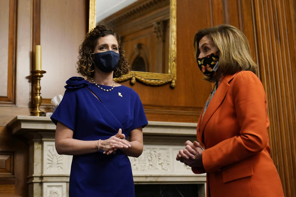 House Speaker Nancy Pelosi of Calif., right, talks with Rep. Julia Letlow, R-La., left, before a mock swearing-in photo opportunity on Capitol Hill in Washington, Wednesday, April 14, 2021. Letlow easily won a special election for the northeast Louisiana-based U.S. House seat that her husband, Luke, couldn't fill because of his death from complications related to COVID-19. (AP Photo/Susan Walsh)
