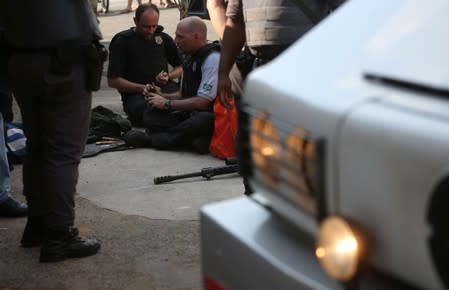 Federal police experts are seen near a site where an armed gang holds people hostage after they robbed a securities company at the Viracopos airport freight terminal, in Campinas