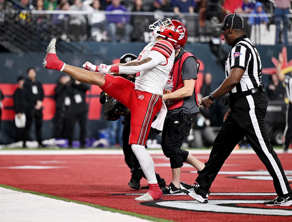 Utah Utes running back Micah Bernard (wearing white) celebrates after scoring a touchdown