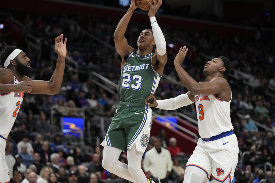 Detroit Pistons guard Jaden Ivey (23) attempts a layup as New York Knicks guard RJ Barrett (9) defends during the first half of an NBA basketball game, Sunday, Jan. 15, 2023, in Detroit. (AP Photo/Carlos Osorio)