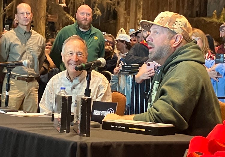 Country music star Garth Brooks, right, sits at a table alongside Bass Pro founder Johnny Morris on Monday at Bass Pro Shops in Springfield.