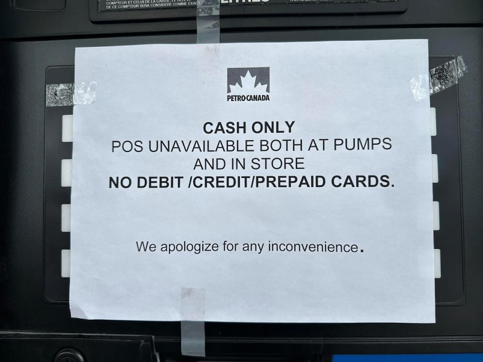 This sign at a Petro-Canada location in Toronto shows the company can't process anything but cash transactions right now. The gas chain's parent company, Suncor, says it has been hit by an unnamed 'cybersecurity incident.' (Greg Ross/CBC - image credit)