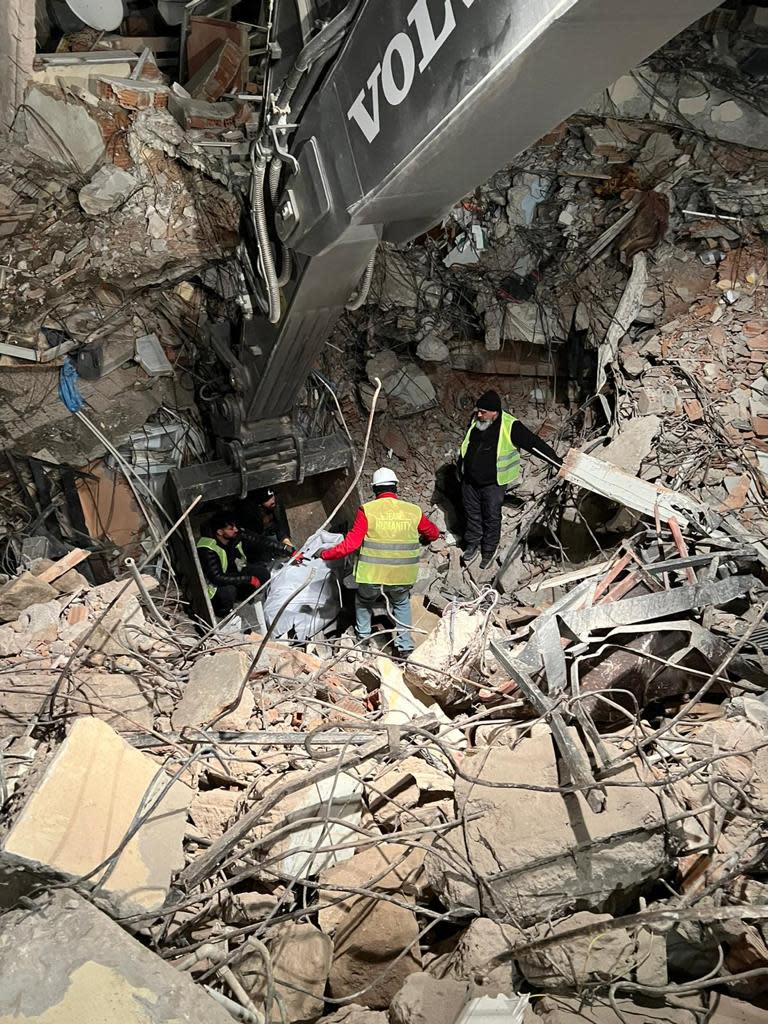 Rescue workers in Antakya, Turkey, recover a body from beneath the rubble in this undated photo.