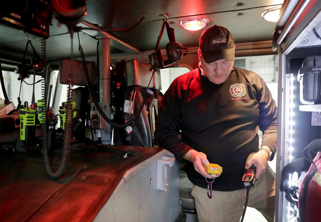 Winneconne-Poygan Fire District Chief Ryan Krings safety-checks a ladder truck at the volunteer department’s fire house in Winneconne.