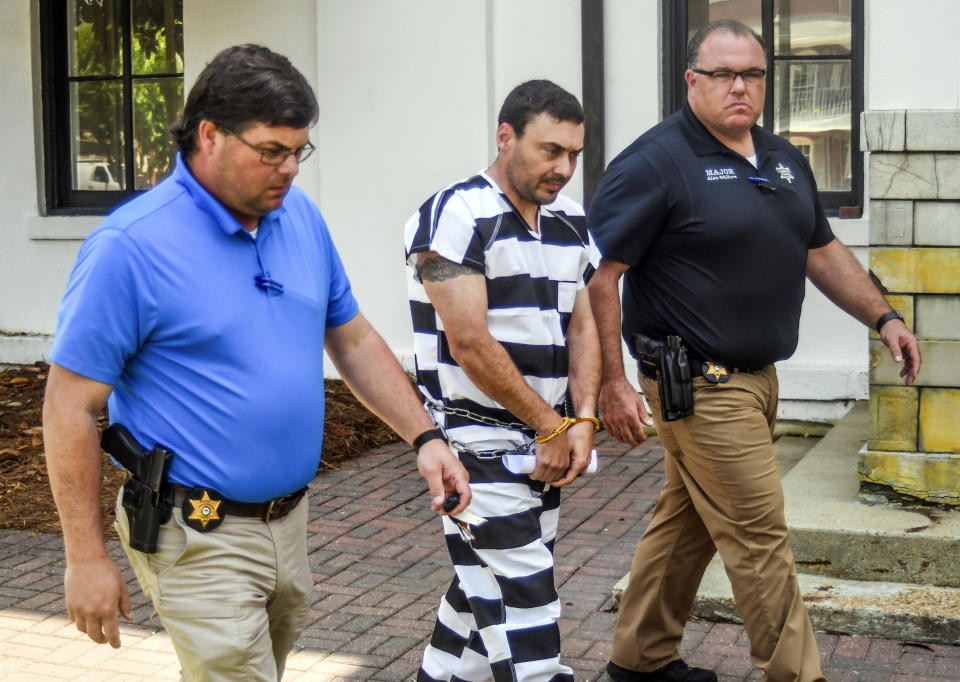 Oxford Police Officer Matthew Kinne, center, escorted by Lafayette County Sheriff deputies Jarrett Bundren, left, and Maj. Alan Wilburn, after hearing at the Lafayette County Courthouse, Wednesday, May 22, 2019, in Oxford, Miss. Kinne is charged in the death of 32-year-old Dominique Clayton, who was found dead Sunday. (Bruce Newman/The Oxford Eagle via AP)