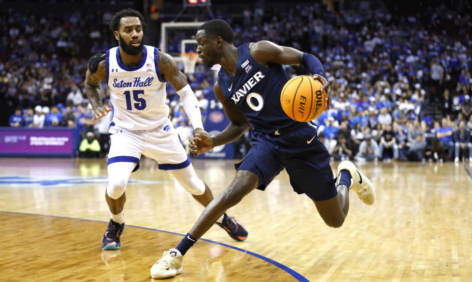 Xavier guard Souley Boum (0) drives to the basket against Seton Hall guard Jamir Harris (15) during the first half of an NCAA college basketball game in Newark, N.J., Friday Feb. 24, 2023. (AP Photo/Noah K. Murray)