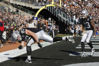 Oakland Raiders tight end Foster Moreau (87) celebrates after scoring a touchdown as tight end Darren Waller (83) looks on during the first half of an NFL football game against the Cincinnati Bengals in Oakland, Calif., Sunday, Nov. 17, 2019. (AP Photo/D. Ross Cameron)