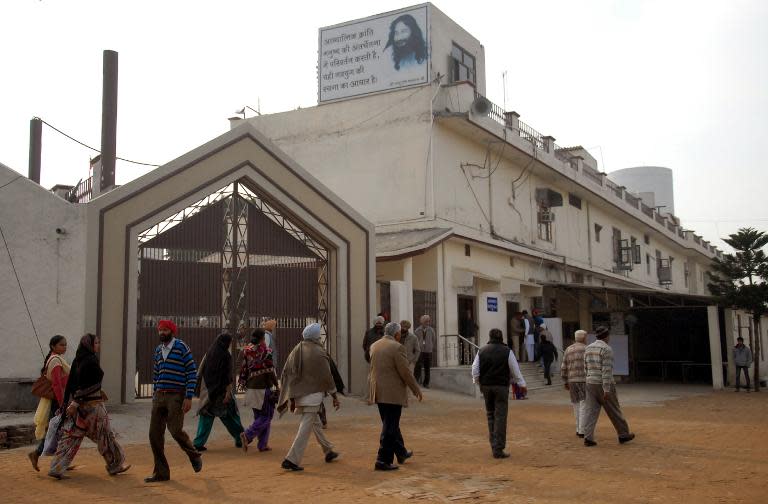 Followers of Indian spiritual leader Ashutosh Maharaj gather outside the Divya Jyoti Jagrati Sansthan in Nurmahal on the outskirts of Jalandhar, after his death, January 29, 2014